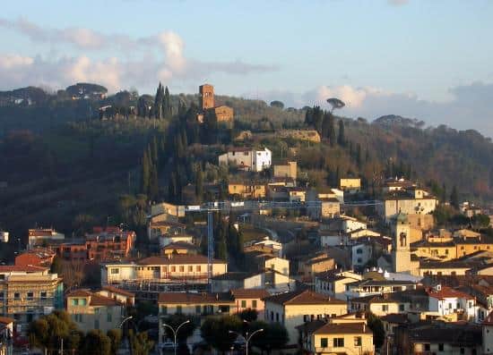 Ancient Florence hillside with historic buildings and lush greenery, showcasing the city's rich arti.